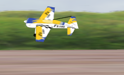 CRRCSim showing a yellow aerobatic aircraft in a low pass